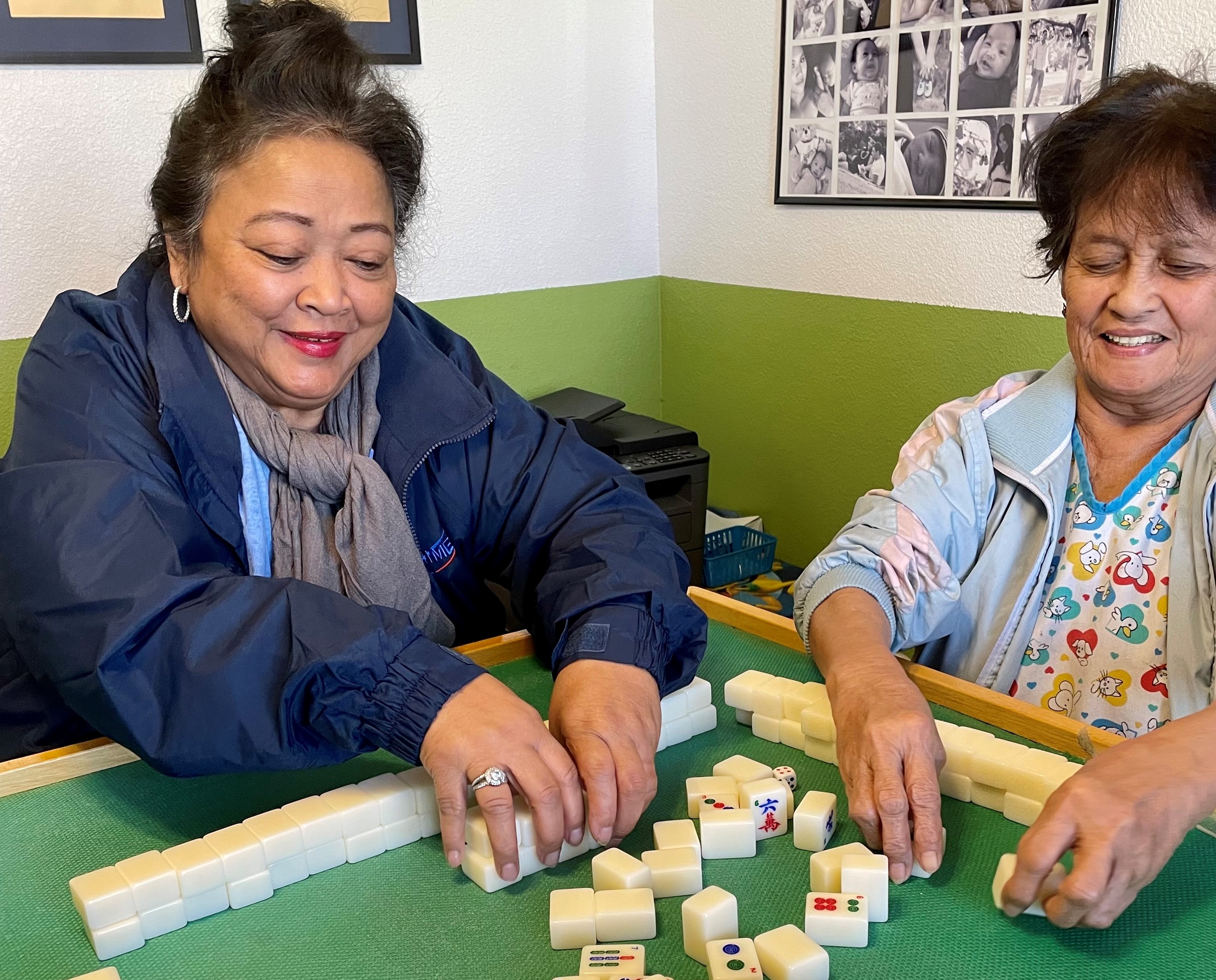 Tessie Raping spends much of her free time playing mahjong with friends and her sister Maxima (right).